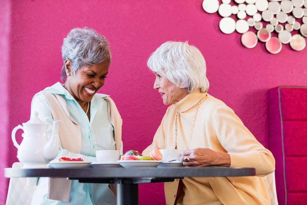 The Cottages of Fox Lake - Assisted Living and Memory Care Senior Living - Nursing home residents snacking on macaroons